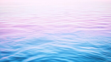 Gentle ripples disturbing the calm water's surface create a beautiful gradient of pink and blue, offering a serene and dreamy backdrop that invites relaxation and inspiration
