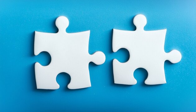 two white puzzle pieces matching together againt light blue background