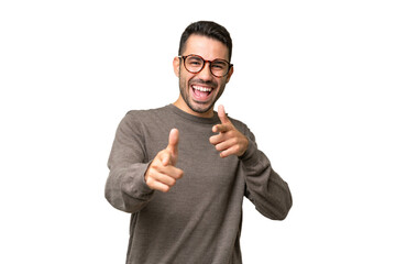 Young handsome caucasian man over isolated background pointing to the front and smiling