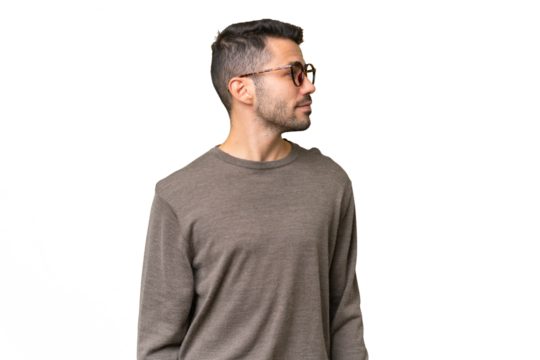 Young handsome caucasian man over isolated background looking to the side