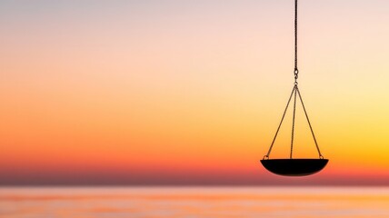 Balance scale silhouette against sunset beach