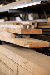 Stack of wooden planks stacked in warehouse in wood workshop