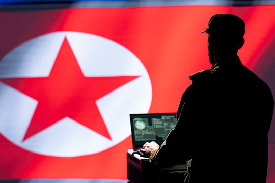 Intelligence officer isolated over North Korea flag monitoring zone of interest using radar. Pyongyang regime operative engaged in surveillance mission using laptop, looking at world map