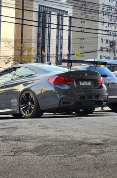 Grey BMW M4 rear end portrait, Luxury modified sportscar on city cenario