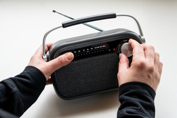 CLose up of  female hands tuning old fashion style radio set