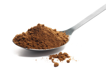 Garam masala ground in metal spoon, minced spice blend, isolated on white, side view