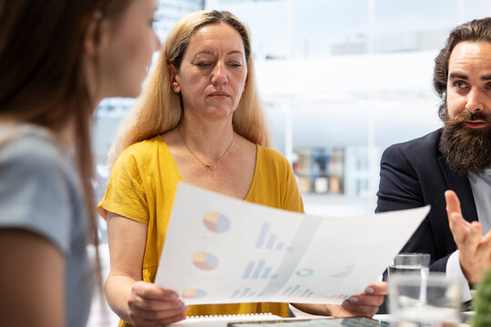 Financial advisor helping family build and maintain healthy budget, avoiding overspending. Consultant in office building emergency fund for clients to cover economic emergencies