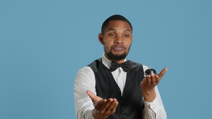 Bellhop doorkeeper ringing the service bell to present his help and assistance upon the guests...