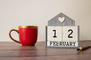 Save the Date written on a calendar - February 12