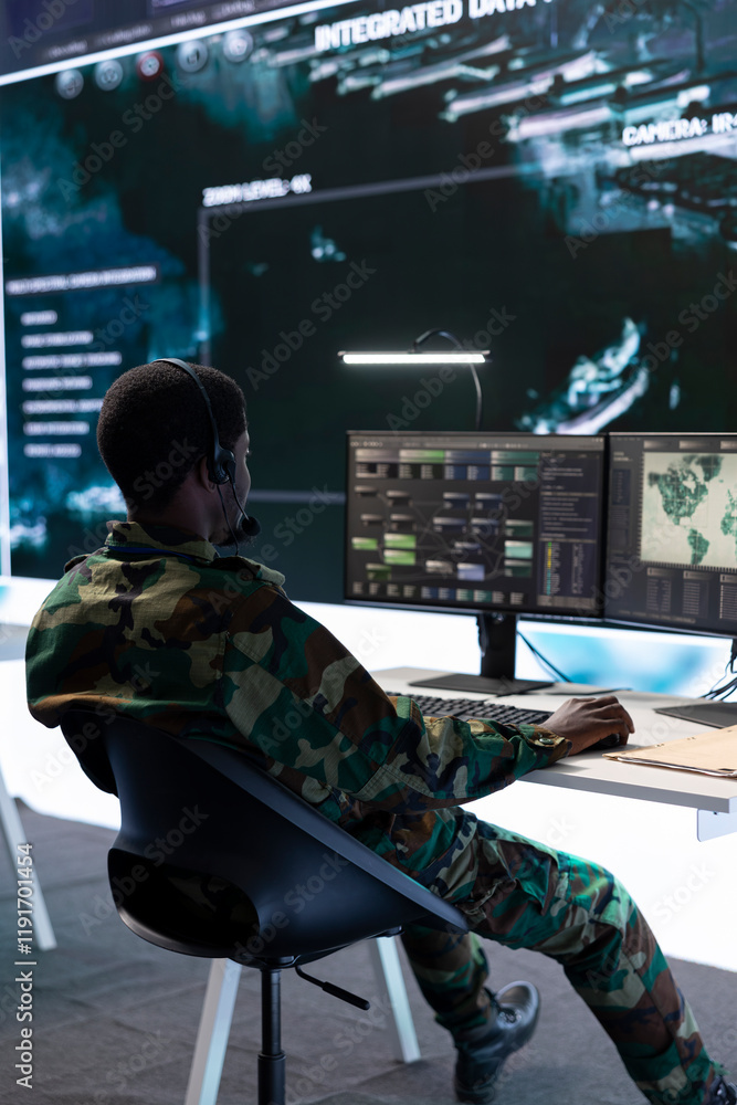 Poster army specialist working with advanced computer systems and cctv data for surveillance missions, gath