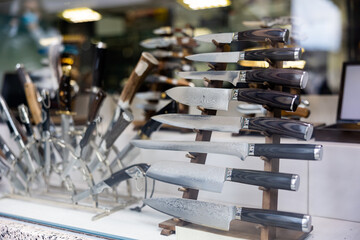 Damascus steel knives in showcase. Toledo knives collection in souvenir shop.