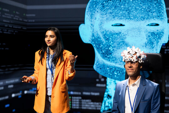 IT company CEO talking at AI expo, sharing neural implants industry insights to audience. Computer scientist at artificial intelligence tech event presenting latest AI EEG headsets products