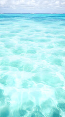 Obraz premium Tranquil Turquoise Ocean Waters Stretch to the Horizon Under a Cloudy Sky