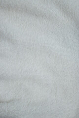Close up of knitted white fabric, abstract textured background 
