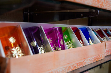 Colorful tea glasses displayed in a souvenir shop in Marrakech.