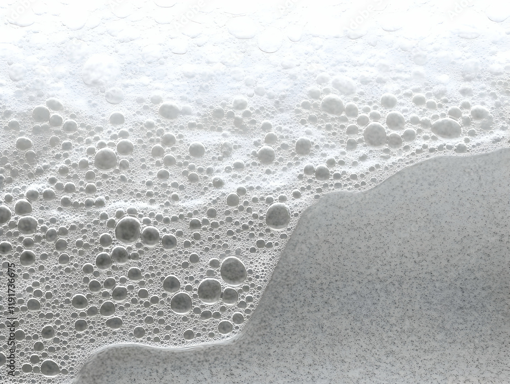 Poster close-up of soap bubbles formation creates an abstract texture on a gray background.