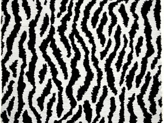 Close-up of Soft Black and White Zebra Print Rug Texture Shows Detailed Fur-Like Fibers Elegantly.