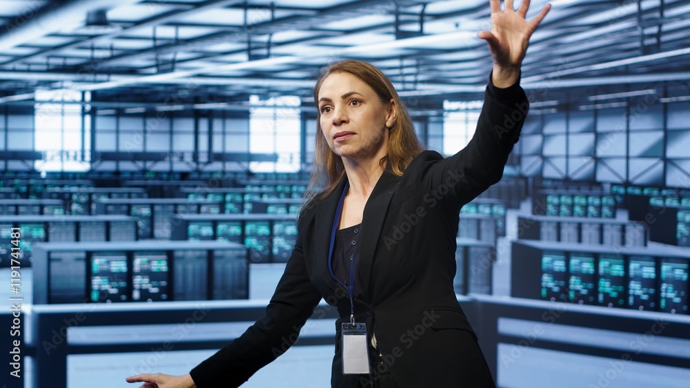 Poster software developer looking at holograms in data center, monitoring infrastructure. woman in server r