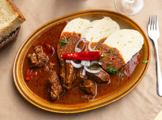 Meat goulash served with dumplings and vegetables, Slovak cuisine dish