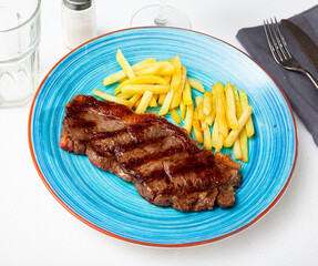 Tasty homemade grilled beef steak served with fried potato ..