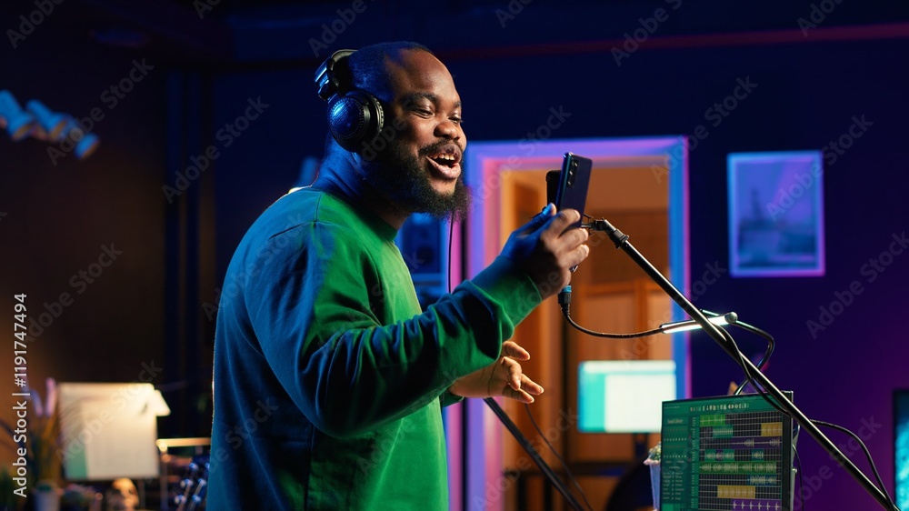 Poster young artist singing his new song creation on microphone gear, editing his recordings to adjust volu