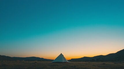 Fototapeta premium Vibrant Camping Tent Under Bright Blue Sky at Dawn in Nature