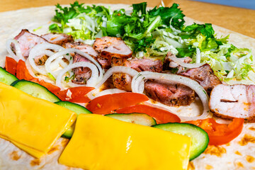 Delicious wrap with grilled meat, fresh vegetables, and cheese at local eatery