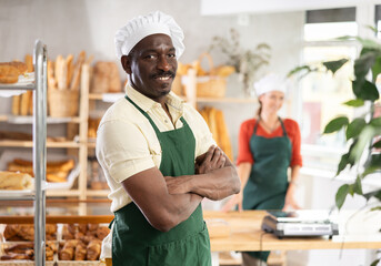 Portrait of professional male baker in uniform in bakery