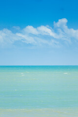 Fototapeta premium Serene seascape with calm turquoise waters under a vibrant blue sky, captured in São Miguel do Gostoso, Rio Grande do Norte, Brazil. A tranquil tropical paradise