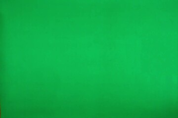 stop motion of the word "TUESDAY" formed by light brown wooden letters against a vibrant green backdrop.
