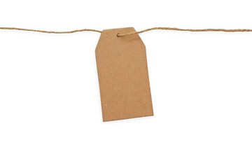 Blank kraft paper tag on a string isolated on white background with clipping path and copy space for text. Brown cardboard label with slim rope cord. Price tag, gift tag, sale tag, address label.