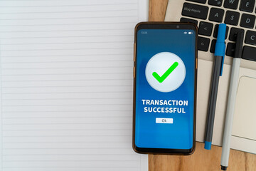 Successful transaction notification on mobile phone app. Concept of sending money through online...