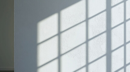 Smooth white wall with subtle natural imperfections and shadows creating geometric pattern. interplay of light and shadow adds depth and interest to space