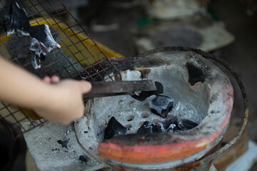 Burning charcoal in the fireplace, close-up of firewood