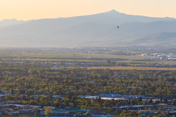 Paraglider Flying Over City