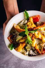 A hearty meal featuring stew, stir-fried chicken, vegetables, and rice on a colorful plate