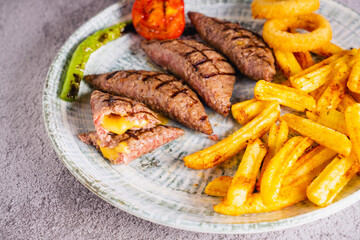 Grilled chicken wings and steak with vegetables on a plate