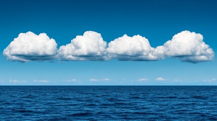 Obraz premium Serene Seascape: Four fluffy cumulus clouds form a picturesque line across a vibrant blue sky above a calm, deep blue ocean, creating a tranquil and minimalist seascape. 