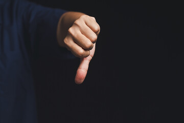 Hand showing thumbs down gesture. Negative feedback or Disapproval concept.