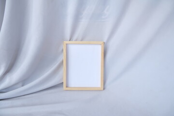 Back View of Wooden Frame with Detailed Texture on White Fabric Background for Mockup Use
