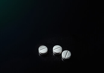White Pills on a Black Background: Highlighting the Opioid Crisis, Addiction, and Substance Abuse – A Powerful Visual Representation of Prescription Drug Misuse, Dependency, and Overdose Awareness