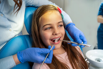 Cute little 10 years old girl having dental checkup 
