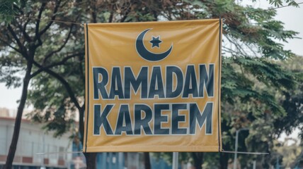 Obraz premium Ramadan Kareem banner hanging outdoors between trees