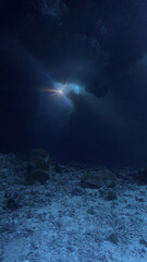 Cathedrals of light. Artistic underwater photo of magic rays of sunlight inside a cave