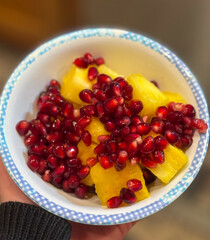 pineapple and pomegranate in a bowl