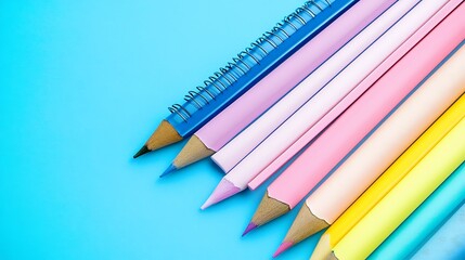 Obraz premium Colorful pencils on blue background, education supplies