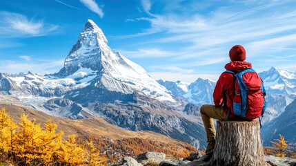 Fototapeta premium A person enjoying a scenic view of a mountain landscape with autumn foliage.