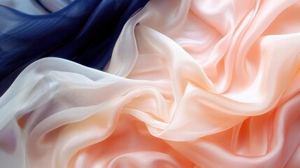 Obraz premium A close-up of flowing, colorful silk fabric in shades of navy, peach, and cream.