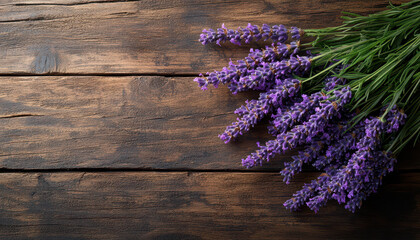 Bundle of fresh lavender flowers lies on rustic wooden table, creating serene and aromatic atmosphere. vibrant purple hues contrast beautifully with textured wood surface