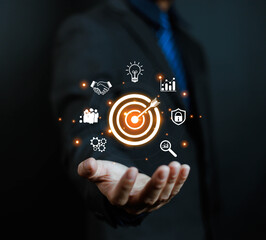 Business goal setting concept. Businessman holding virtual target icon for business purpose. Strategic planning for business growth. Marketing strategy and goal for success.